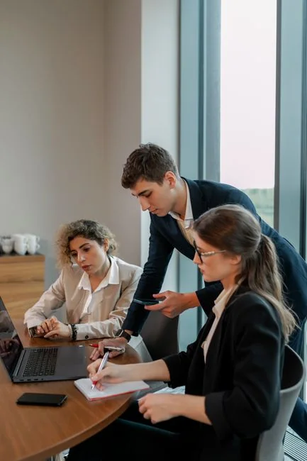 A group of business professionals working together in an office environment.